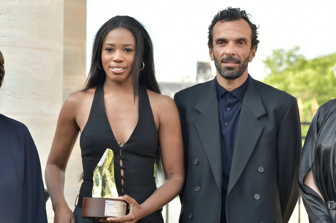 Cédric Charbit standing beside an award recipient holding the ANDAM Fashion Award Paris 2021 trophy at the ceremony